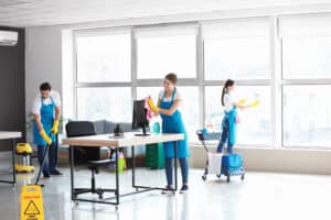 Team of janitors cleaning office
