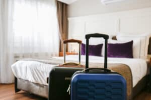 Two packed suitcases prepared for the trip. Traveling couple concept. Hotel room bed 