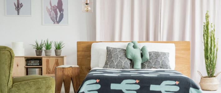 Managing an Airbnb: How to Create the Ultimate Rental Cactus themed room with wooden and velvet furniture that has been professionally cleaned by The Magic Helpers.