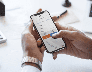 on demand Person holding a phone in their hands. On the phone is a graph of on-demand Airbnb cleaning services/
