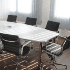 Rectangle 10 copy 3 Board room table with rolling chairs after being professionally cleaned by The Magic Helpers.