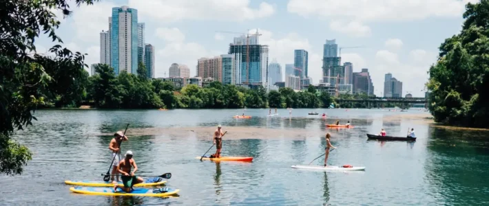 Paddle boarders on Lady Bird Lake in Austin, Texas, having found a vacation rental that met their needs.