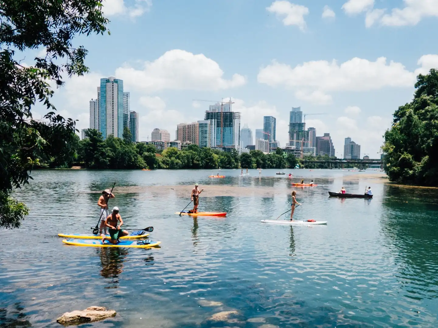 Paddle boarders on Lady Bird Lake in Austin, Texas, having found a vacation rental that met their needs.