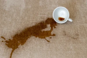 Coffee spilt on a couch ottoman.